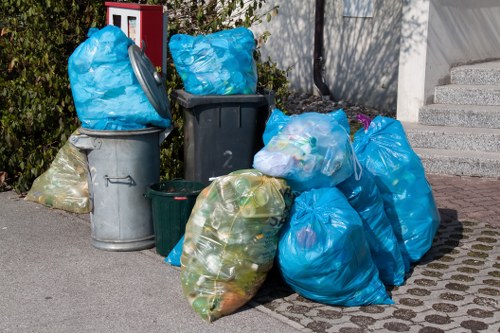 Workers clearing waste from a small retail unit